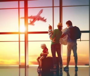 A group of people standing in front of an airport window.