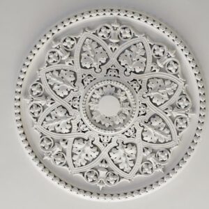 A white ceiling medallion with intricate designs.