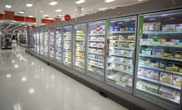 A large display freezer in a store filled with food.