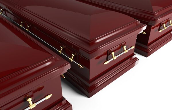 A group of three red caskets with gold handles.