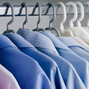 A row of shirts hanging on the rack.