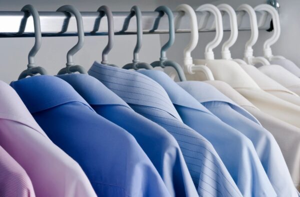 A row of shirts hanging on the rack.