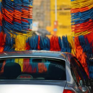 A car is being washed in the street.