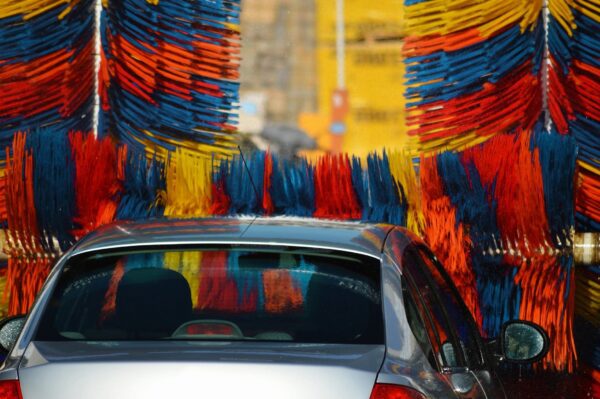 A car is being washed in the street.