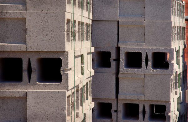 A building with many blocks of concrete in the corner.