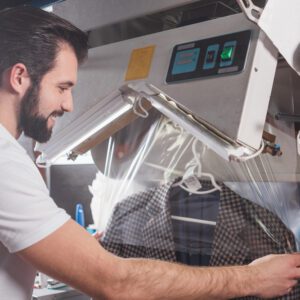 A man is working on an ironing machine