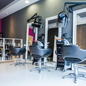 A hair salon with many chairs and mirrors