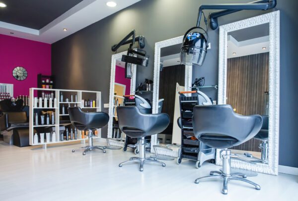 A hair salon with many chairs and mirrors