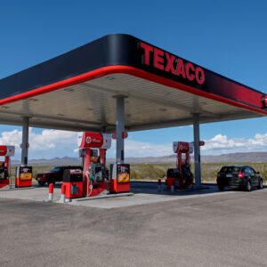 A gas station with cars parked at the pumps.