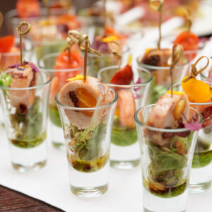 A table with many glasses of food on it