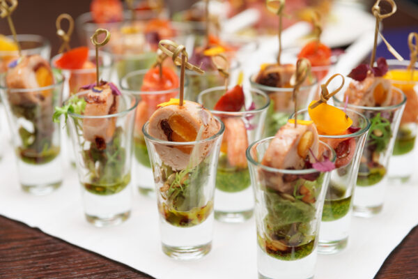 A table with many glasses of food on it