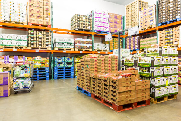 A warehouse filled with lots of boxes and pallets.