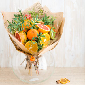 A bouquet of fruit in a vase on the table