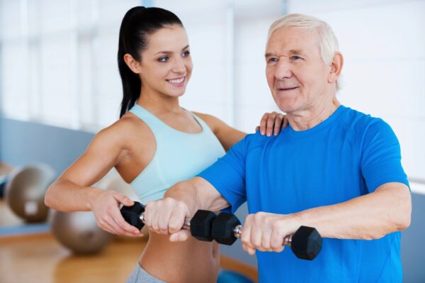 A woman and an older man are working out