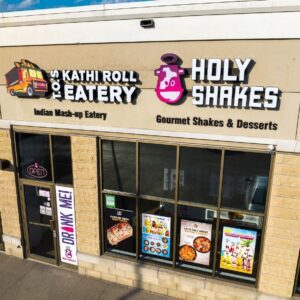 A store front of a restaurant with many different types of food.