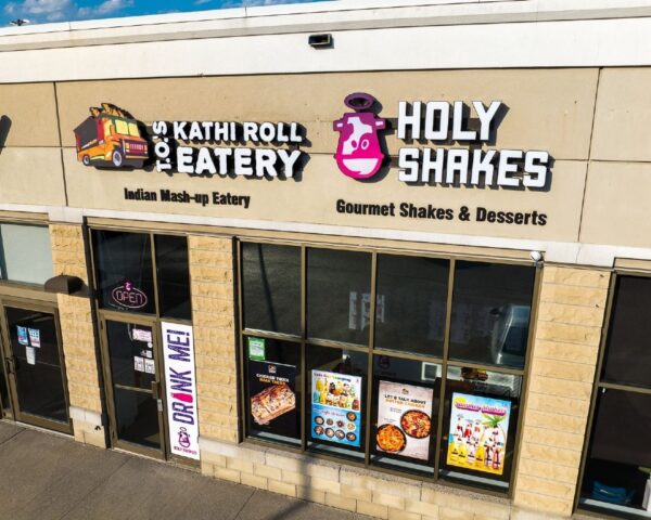 A store front of a restaurant with many different types of food.