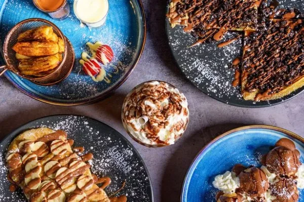 A table topped with plates of food and bowls.