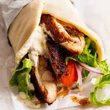 Chicken shawarma wrap with lettuce and tomato.